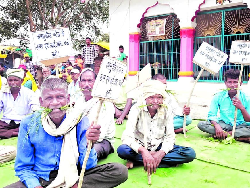 मुंह में चारा दबाकर आदिवासियों का प्रदर्शन, जमीन कब्जे के आरोपों से बढ़ा प्रशासनिक दबाव मुंह में चारा दबाकर आदिवासियों का प्रदर्शन, जमीन कब्जे के आरोपों से बढ़ा प्रशासनिक दबाव